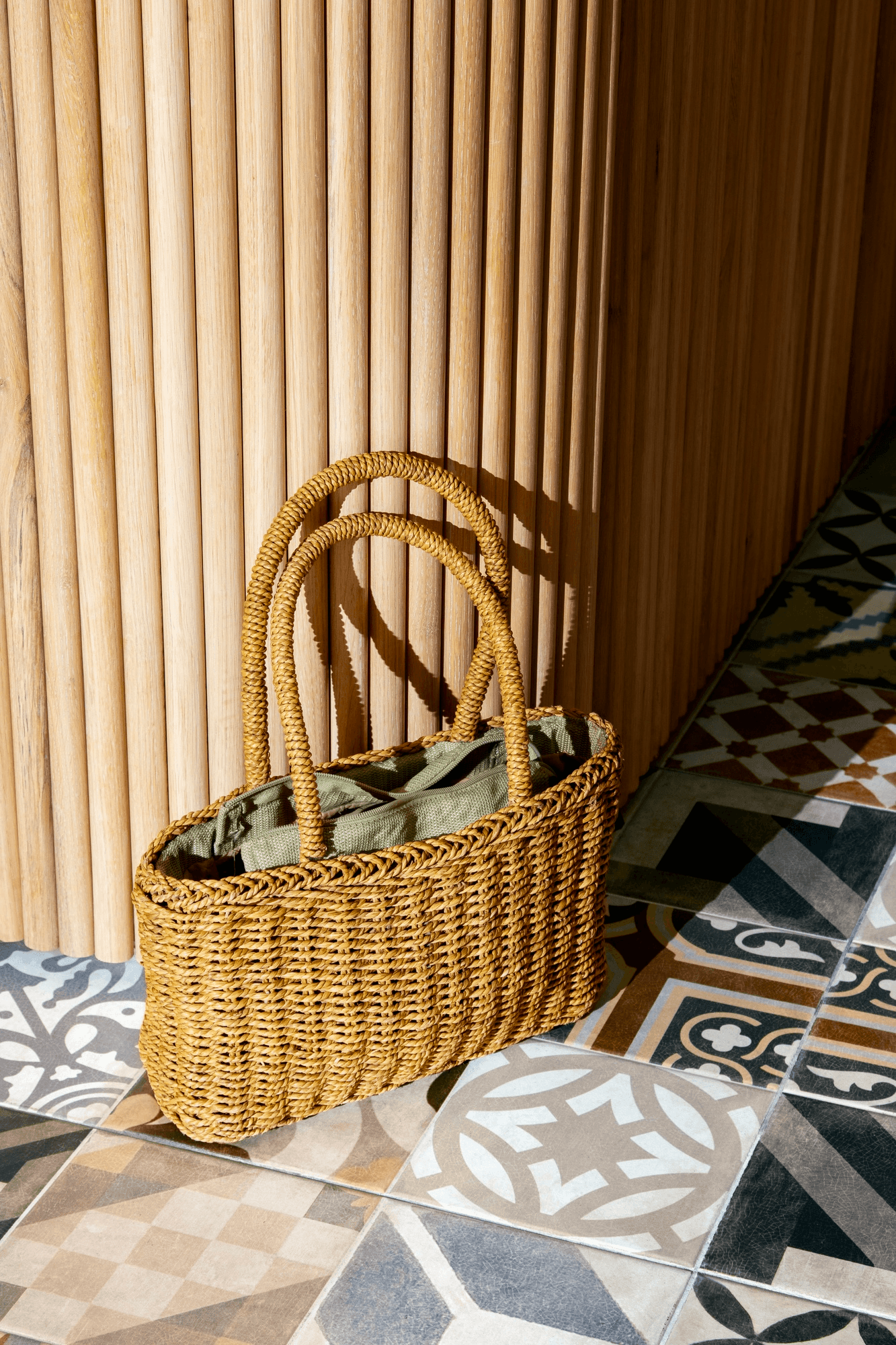 Straw handbag on patterned floor